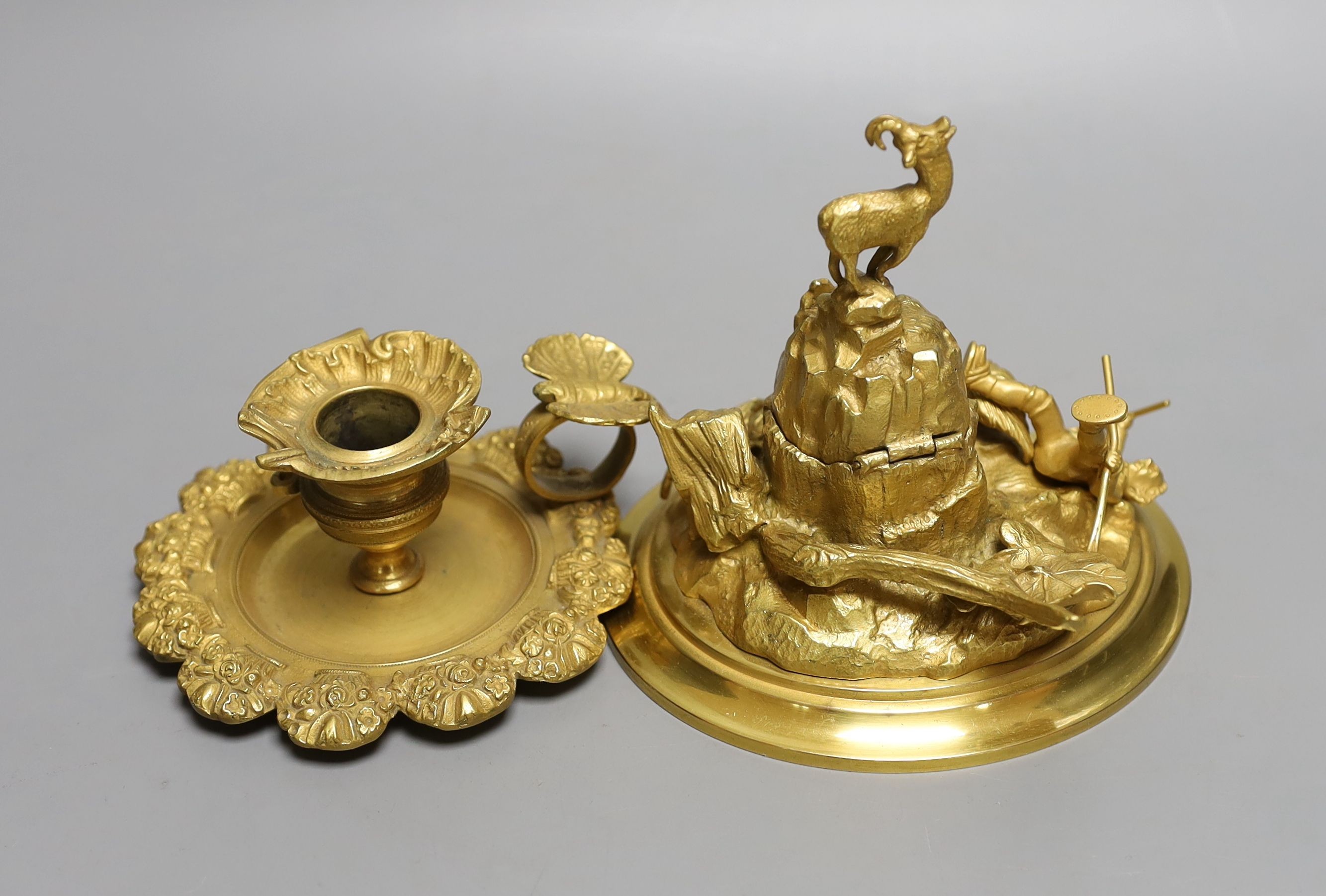 An ormolu mountainous and figurative inkstand and butterfly handled chamber stick, Inkwell 13cms high.